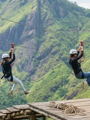 Rider soaring on the Flying Ravana mega zipline over tea estates in Ella Sri Lanka