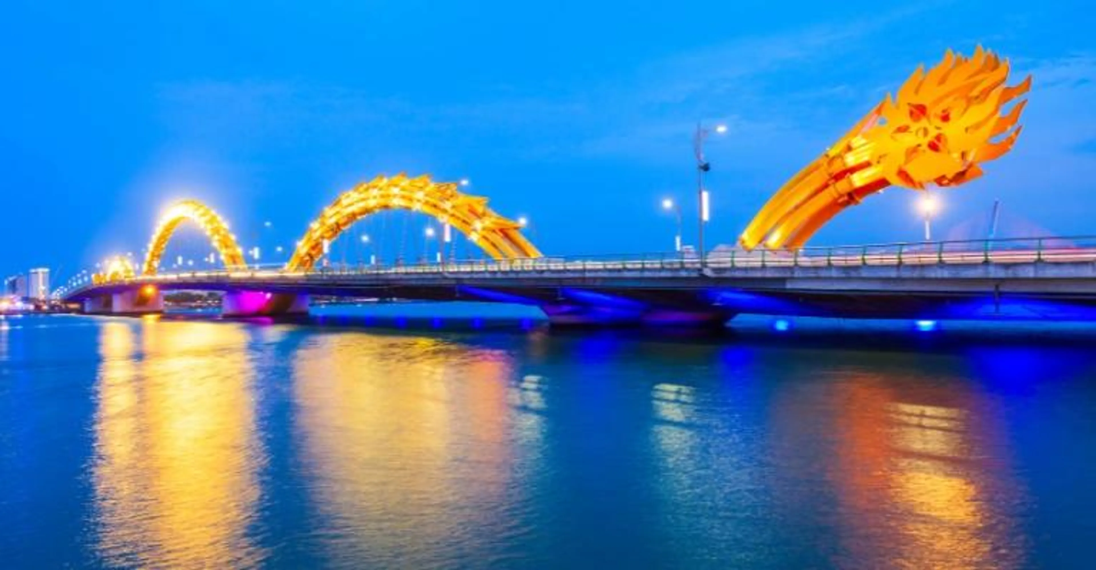Dragon Bridge in Danang illuminated gold at night
