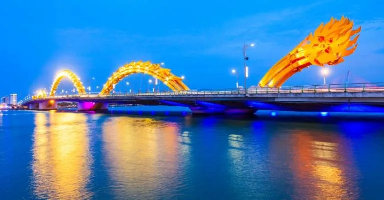 Dragon Bridge in Danang illuminated gold at night