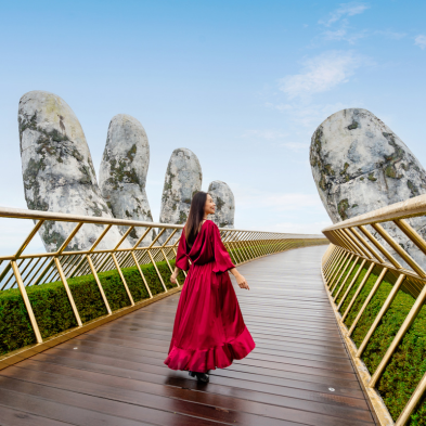 Golden Bridge in Bana Hills supported by giant stone hands above the mountains
