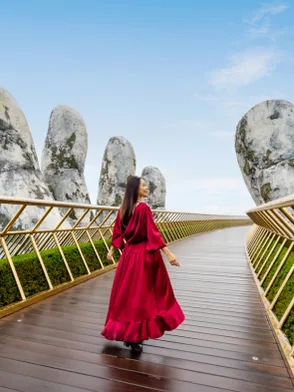 Golden Bridge in Bana Hills supported by giant stone hands above the mountains