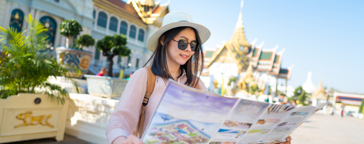 Tourist reading a map at the Grand Palace in Bangkok