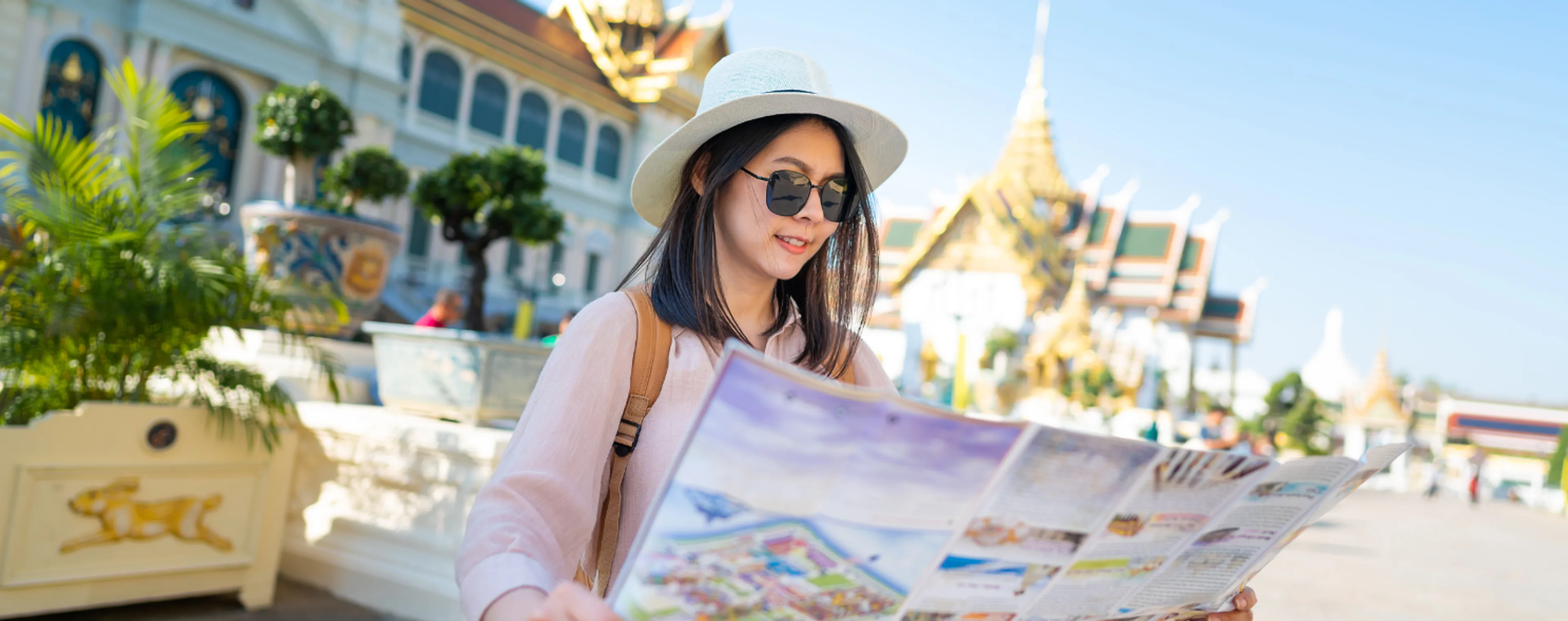 Tourist reading a map at the Grand Palace in Bangkok