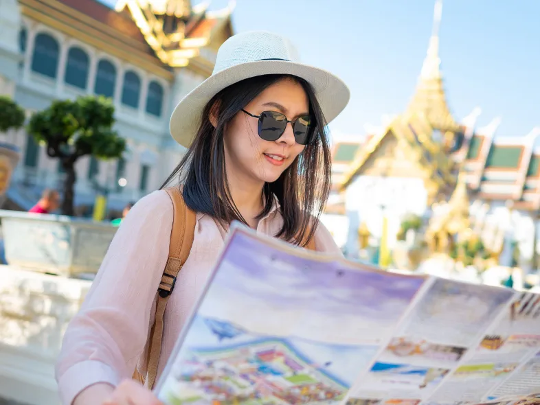 Tourist reading a map at the Grand Palace in Bangkok