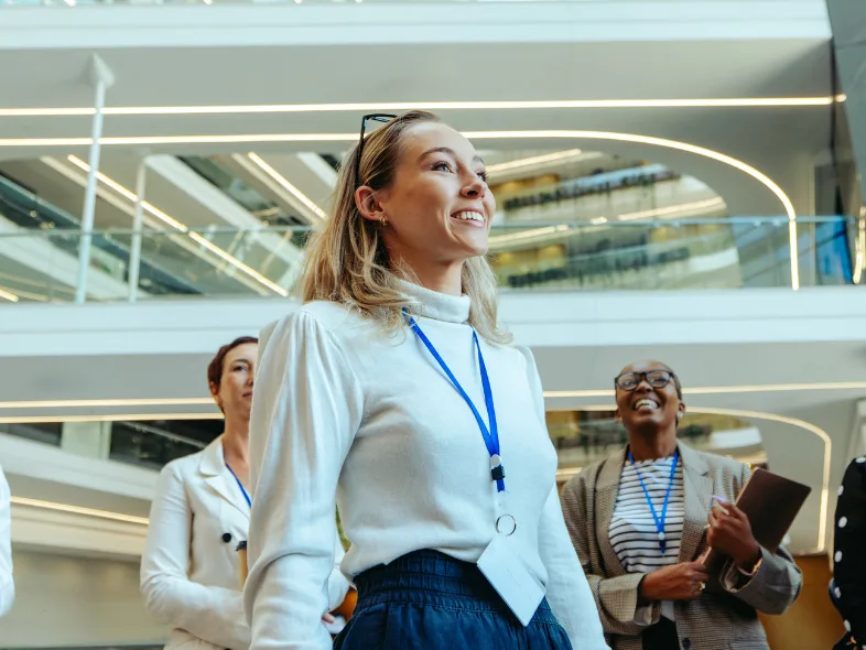 Group of smiling business professionals gathered in a modern office lobby
