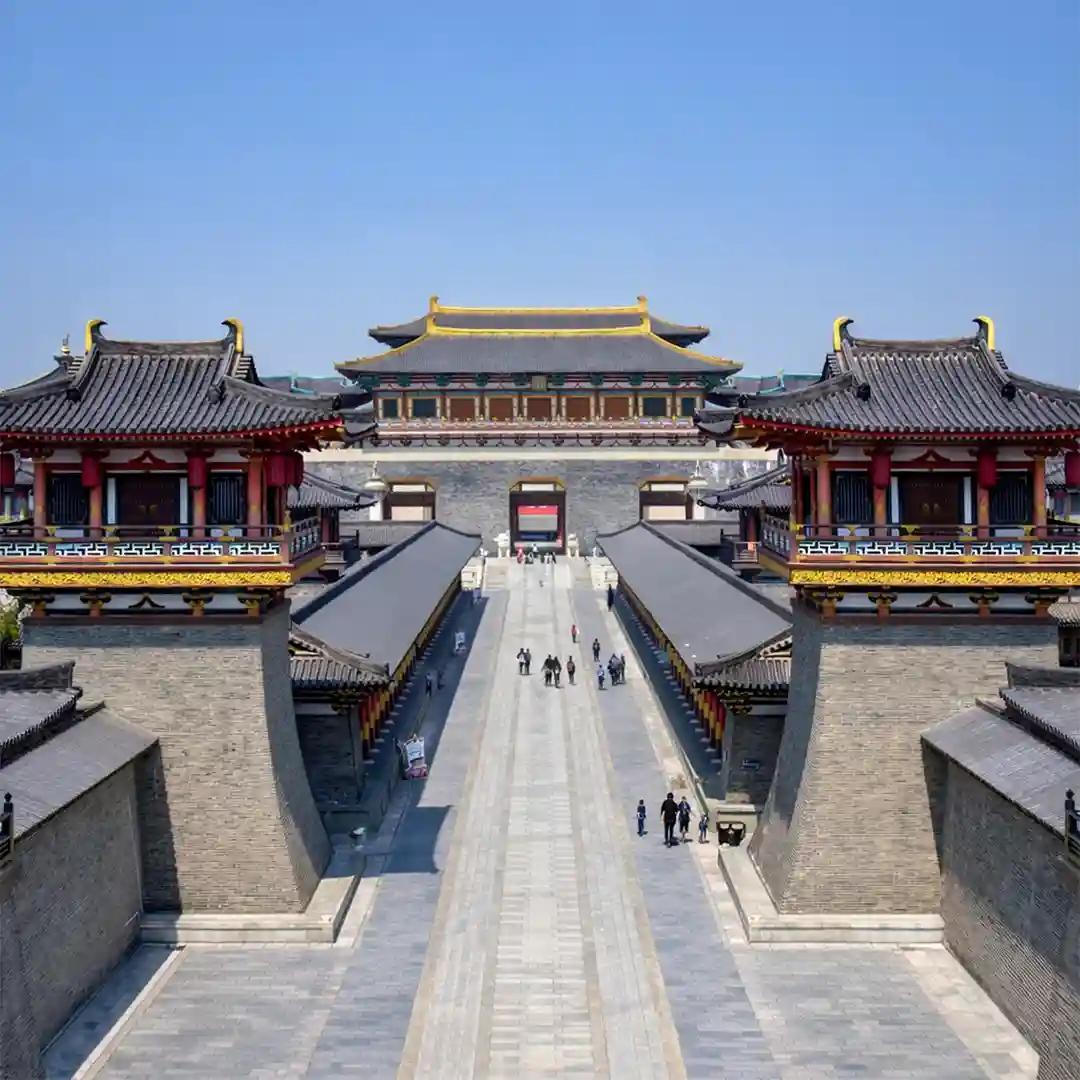 Tang Dynasty Unceasing City Xi'an at night with illuminated streets, traditional buildings, and cultural performances