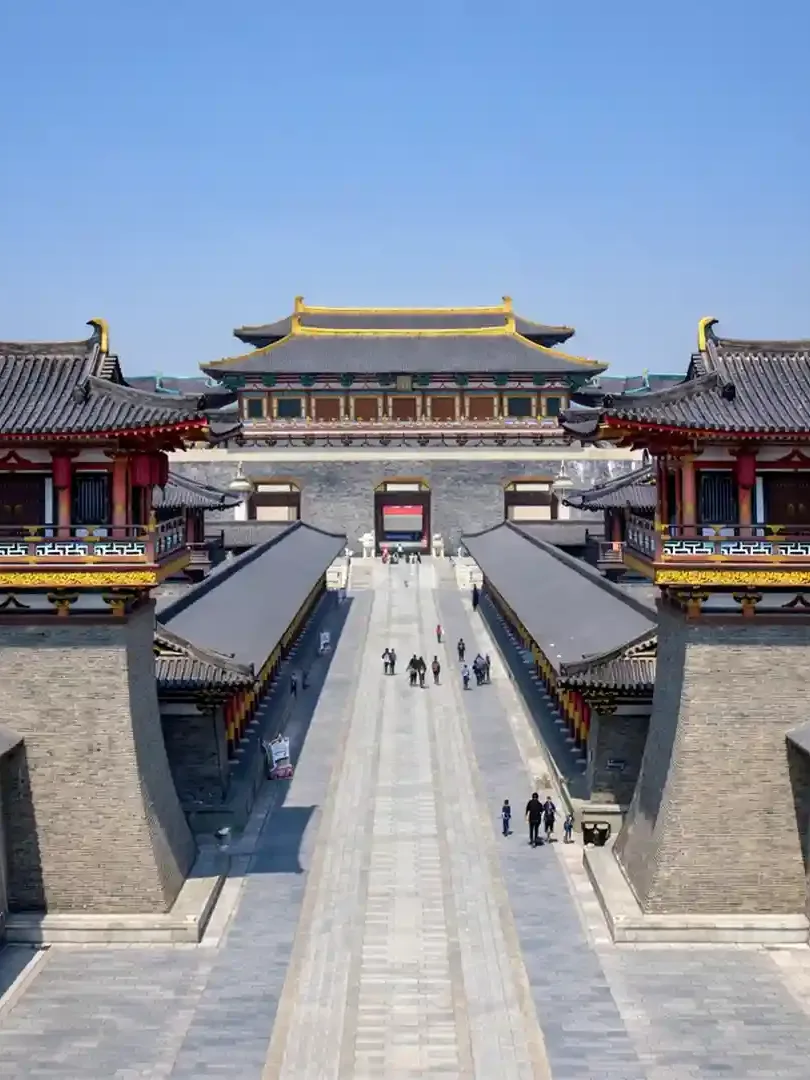 Tang Dynasty Unceasing City Xi'an at night with illuminated streets, traditional buildings, and cultural performances