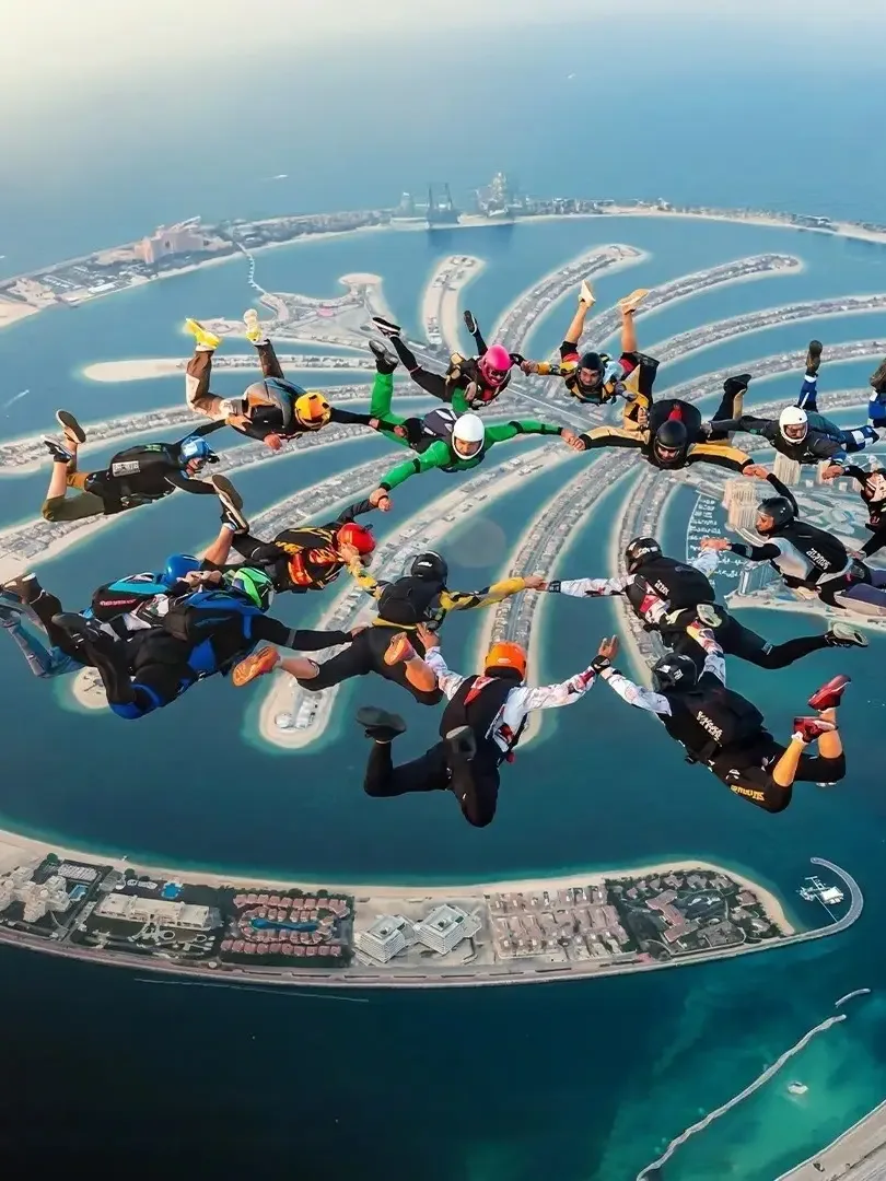 Skydiving over Palm Jumeirah with aerial view of Dubai coastline