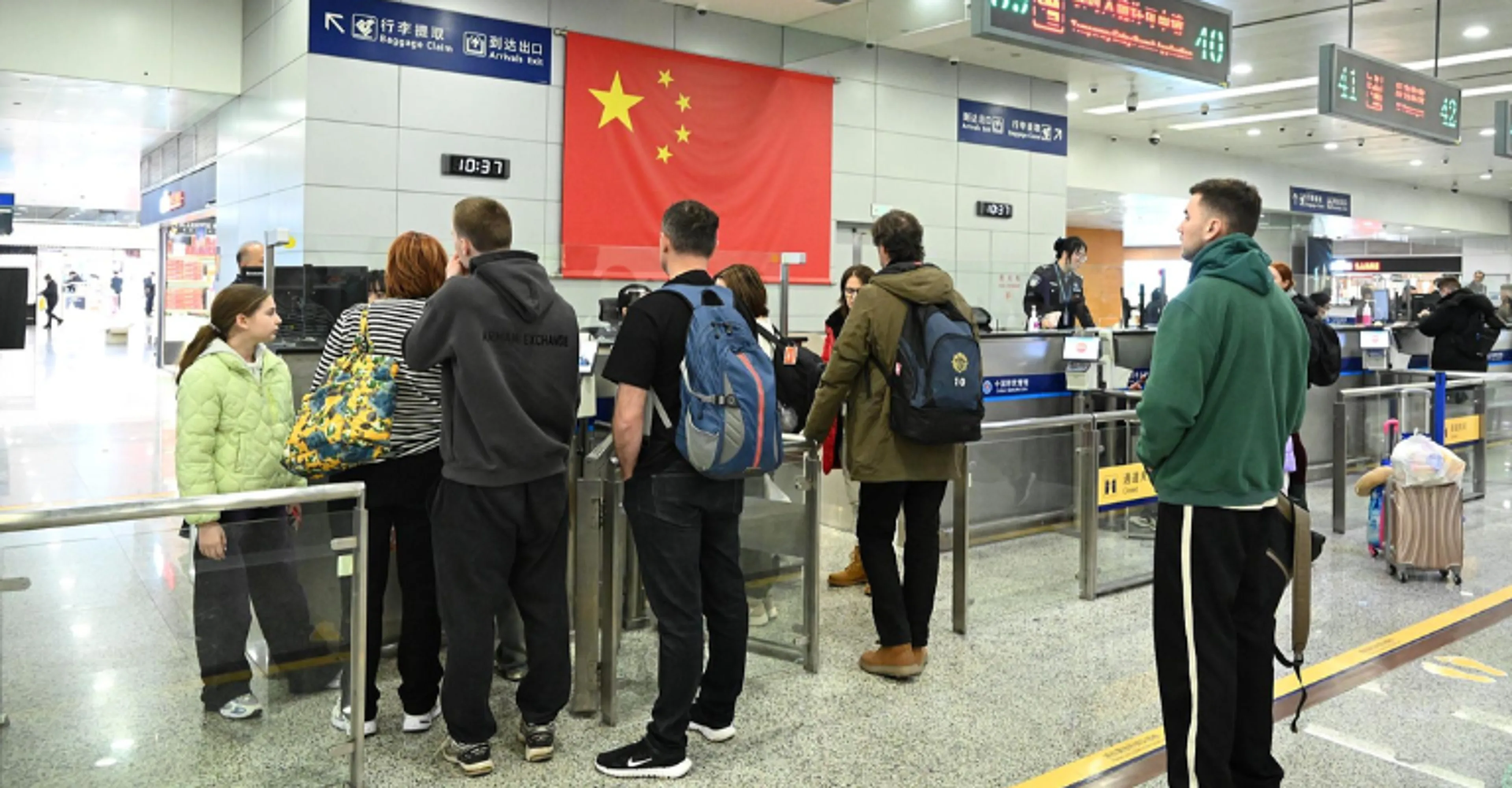 International travelers passing through arrivals and immigration control at a Chinese airport