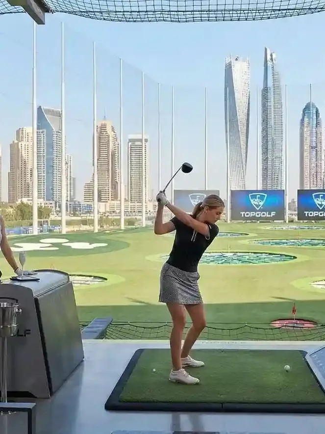 Golf course in Dubai with lush green fairways and modern skyline backdrop
