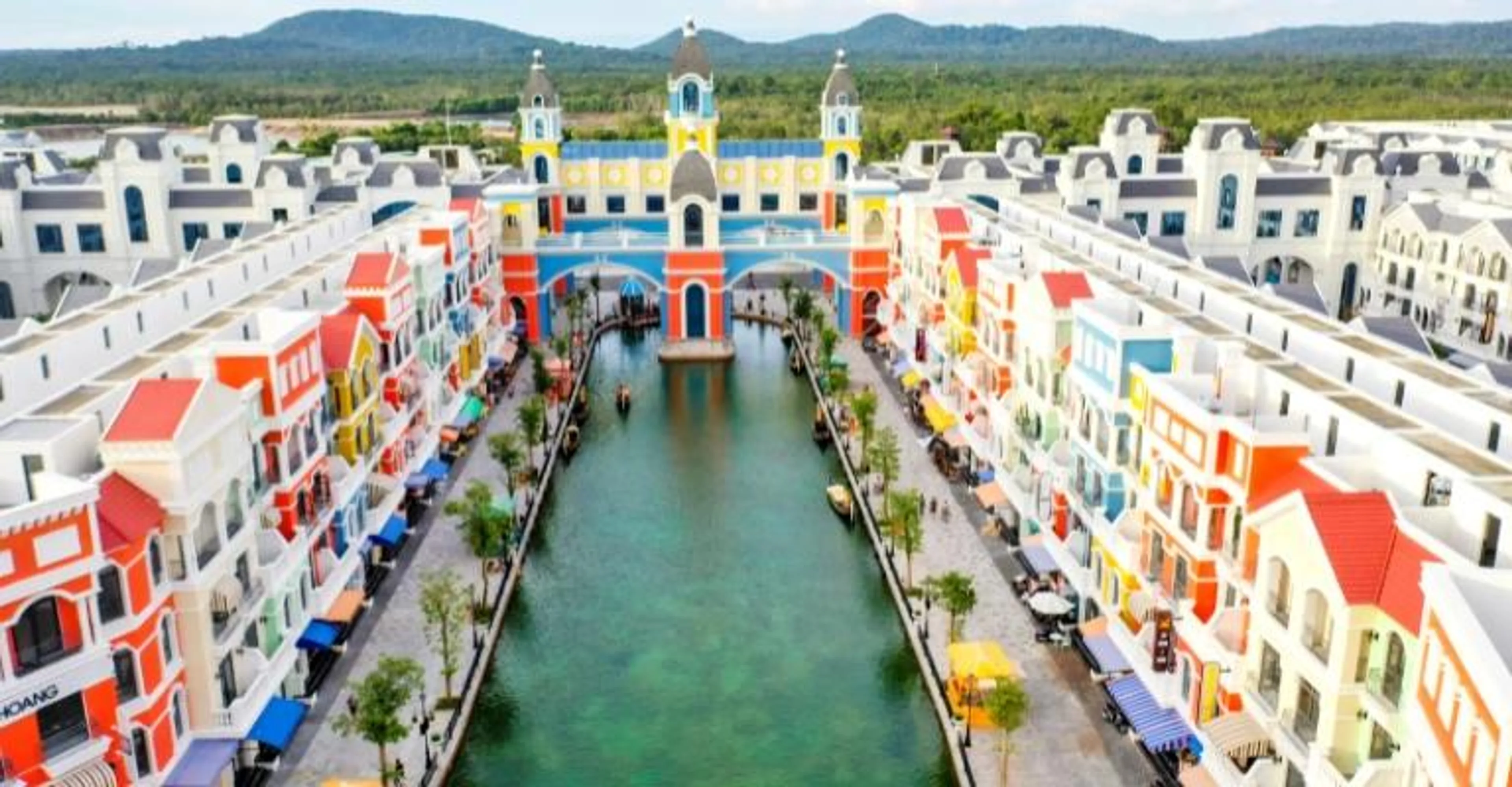 Aerial view of the colorful waterfront shophouses and canal at Phu Quoc's Grand World