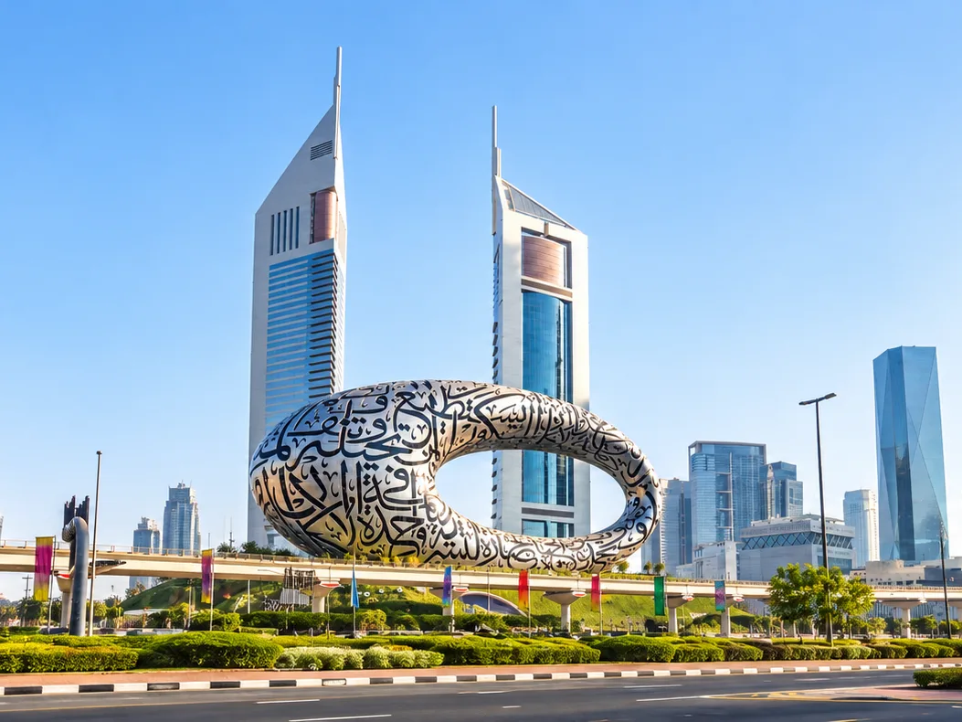 Museum of the Future ring sculpture in Dubai with the Emirates Towers skyline behind it