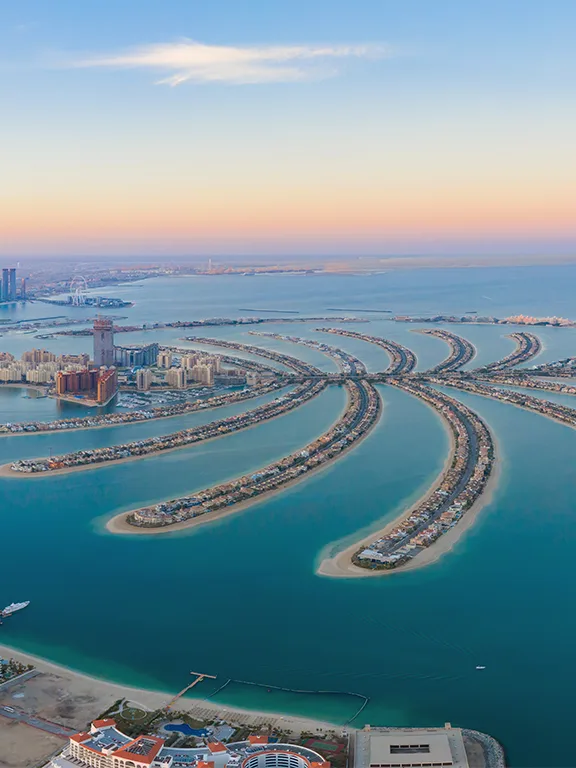 Aerial view of Palm Jumeirah and the Dubai skyline at sunset