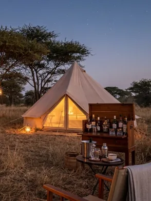 Private mobile tented fly-camp set up in the African bush with a bonfire at night, Kenya