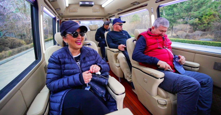 International travelers relaxing in a private China DMC coach transfer between destinations