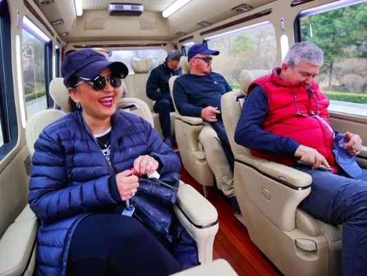 International travelers relaxing in a private China DMC coach transfer between destinations