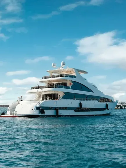 Luxury yacht cruising along Dubai coastline with skyline in the background
