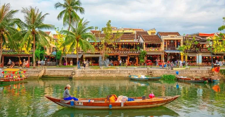 A boat on the river in front of Hoi An's lantern-lit ancient town waterfront