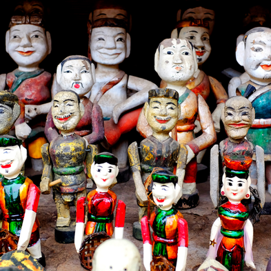 Traditional Vietnamese water puppet performance with colorful puppets on stage