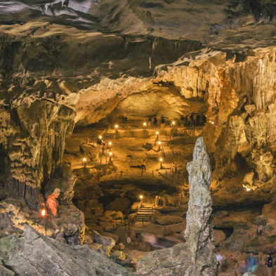 Explorers wading through an underground river in the Tu Lan Cave System Vietnam