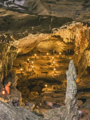 Explorers wading through an underground river in the Tu Lan Cave System Vietnam