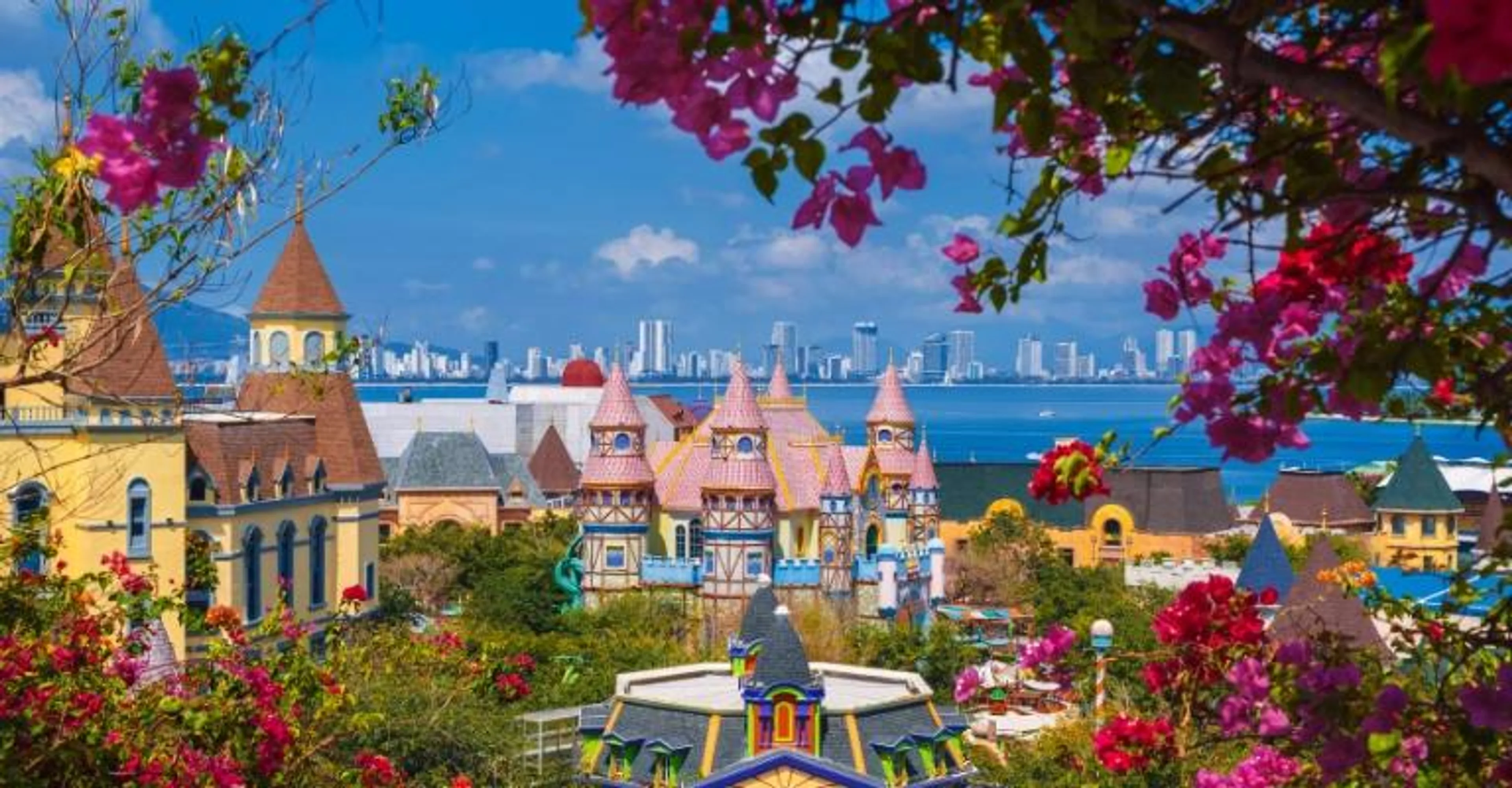 Fairytale-style towers of VinWonders Phu Quoc framed by bougainvillea