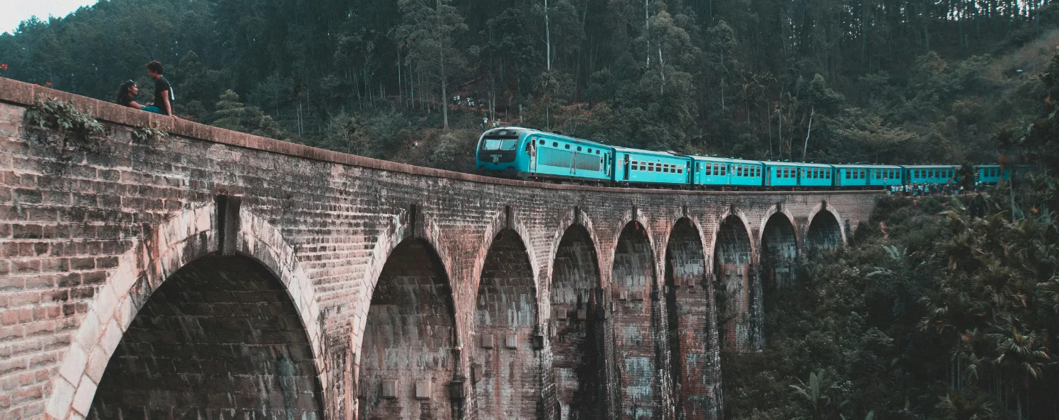 The blue hill-country train crossing the Nine Arches Bridge near Ella, Sri Lanka