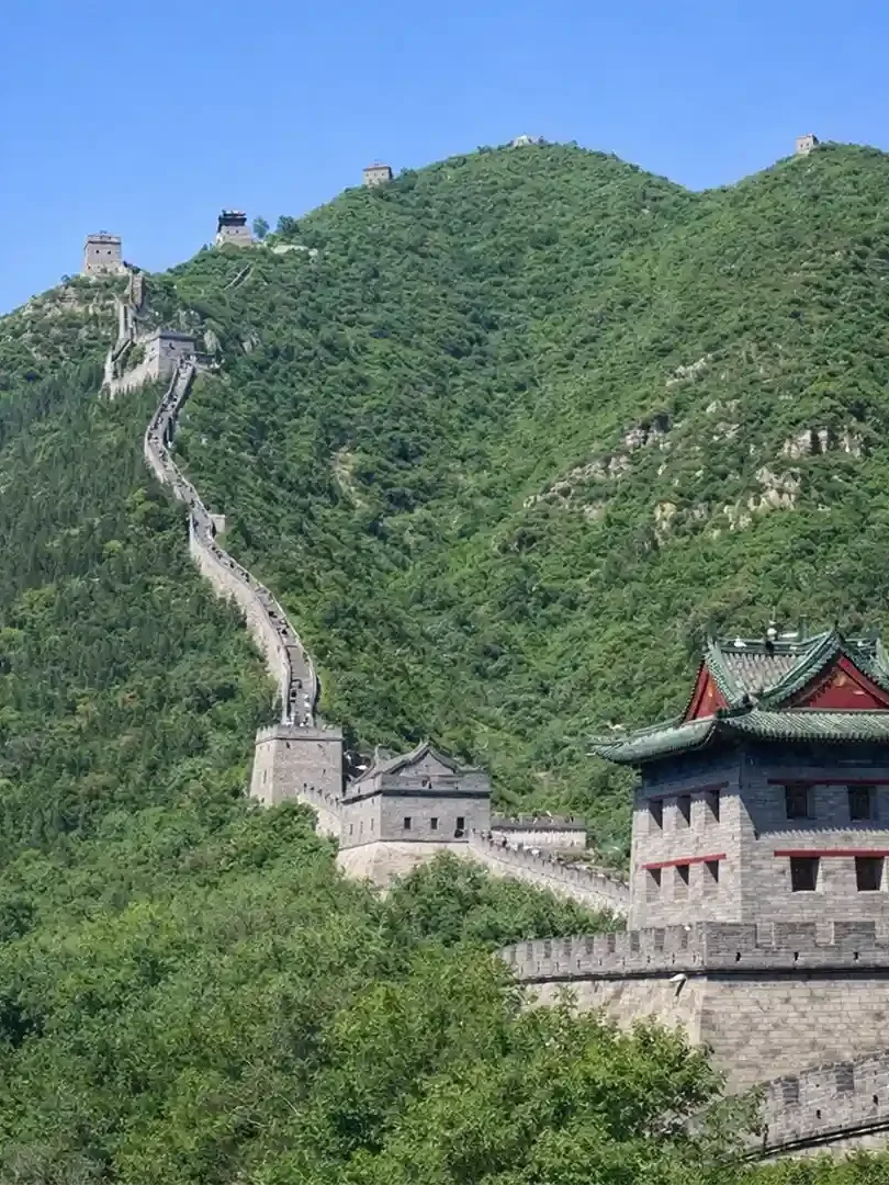 Great Wall of China stretching across mountains with stone pathways and scenic landscape views
