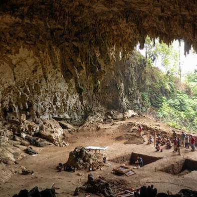 Explorers inside the limestone cave complex and temple at Batatotalena Sri Lanka