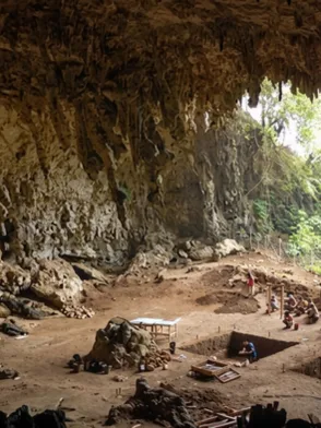 Explorers inside the limestone cave complex and temple at Batatotalena Sri Lanka
