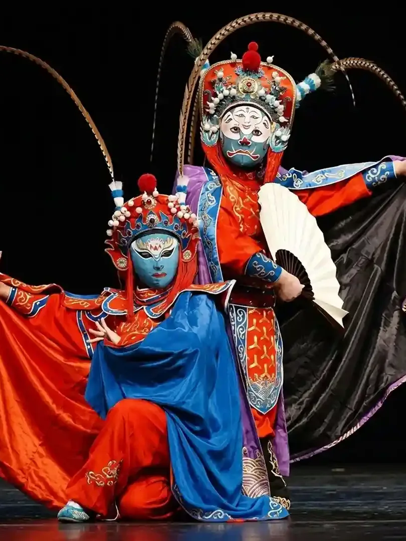 Sichuan Opera face-changing performance with colorful costumes and dramatic mask transformation on stage