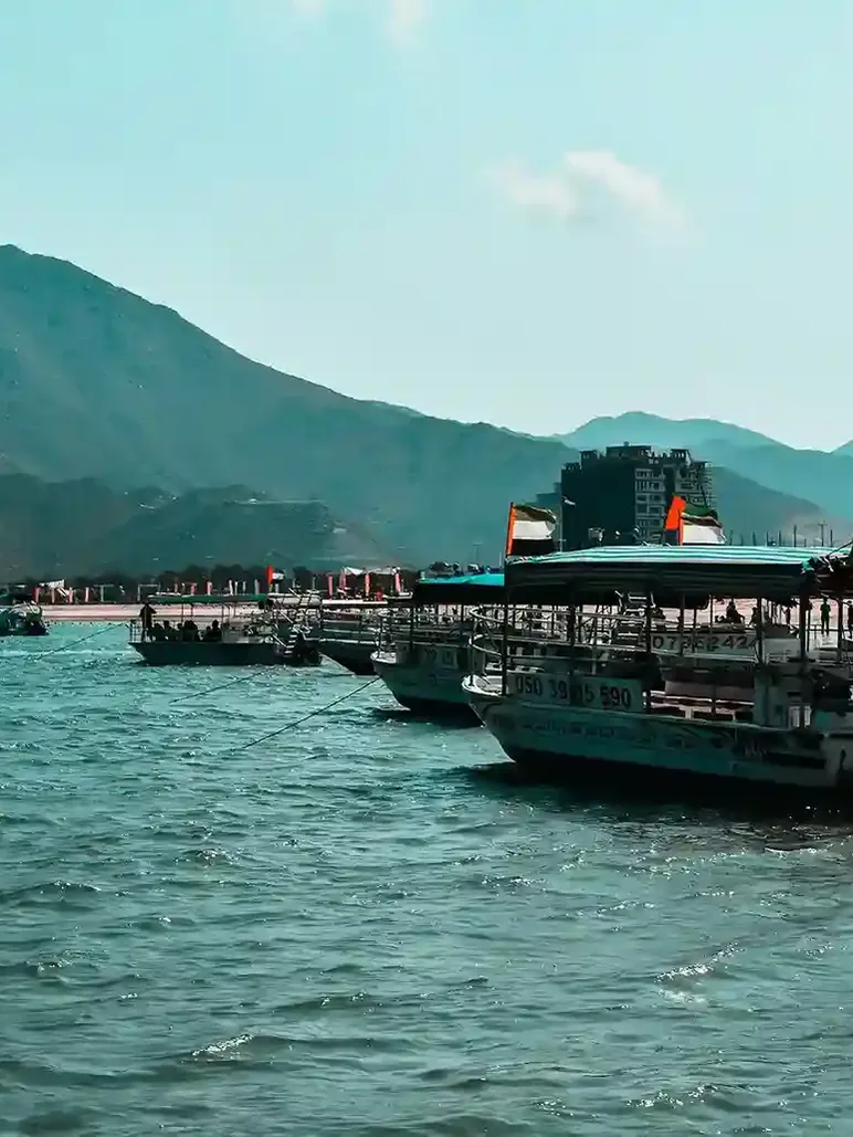 Khor Fakkan beach with mountains, clear water, and scenic coastal views