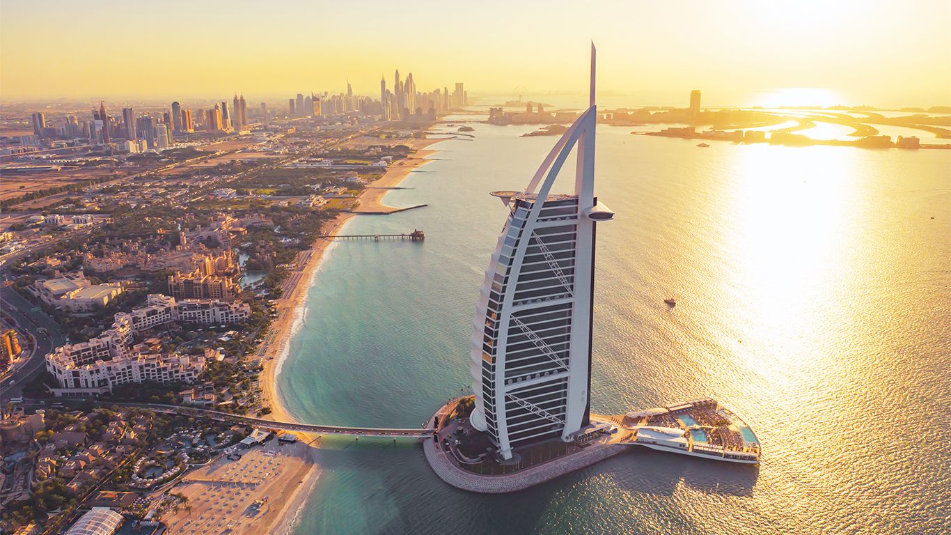 Aerial view of the Burj Al Arab and Dubai coastline at sunset