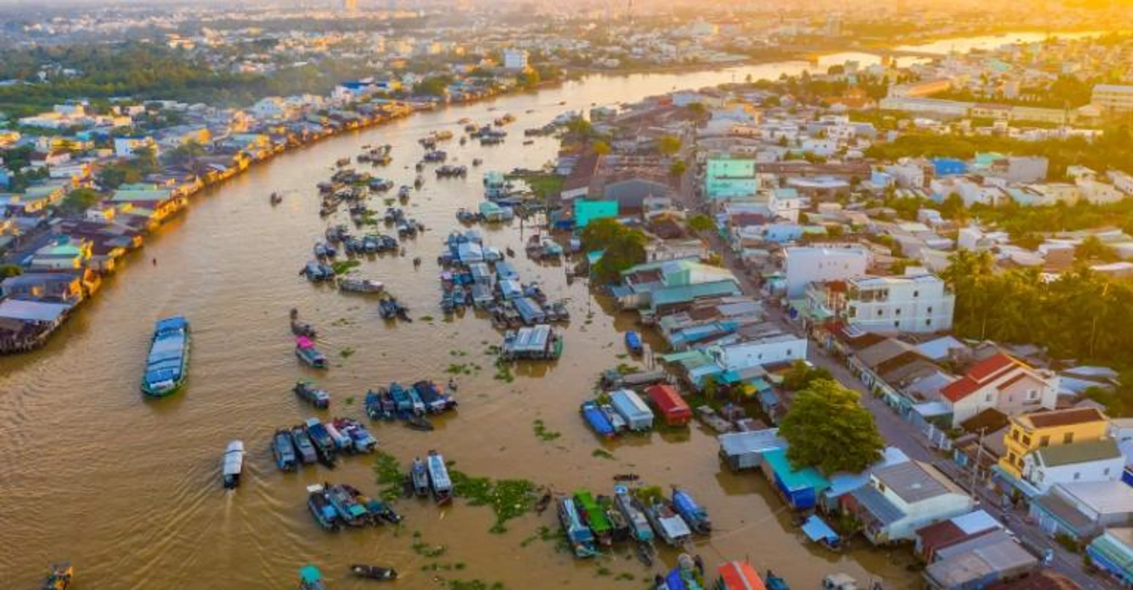 Aerial view of boats and floating markets along a river in the Mekong Delta