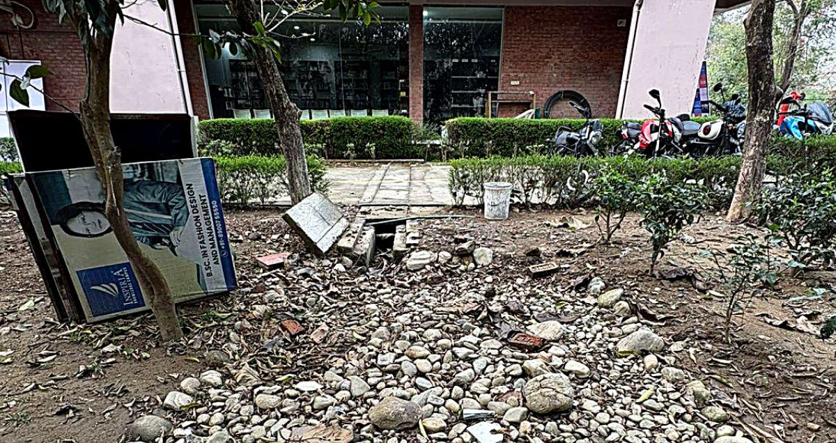 A completed recharge bed at Block B, Inspiria Knowledge Campus — a covered pit set into a landscaped pebble bed among the campus greenery