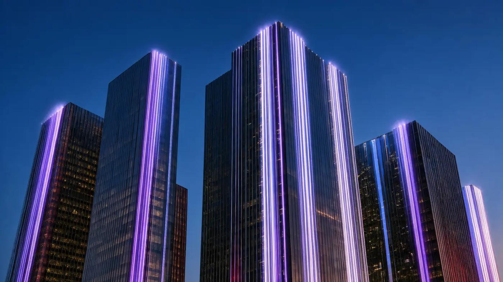 Glass towers at dusk with violet light running up their edges
