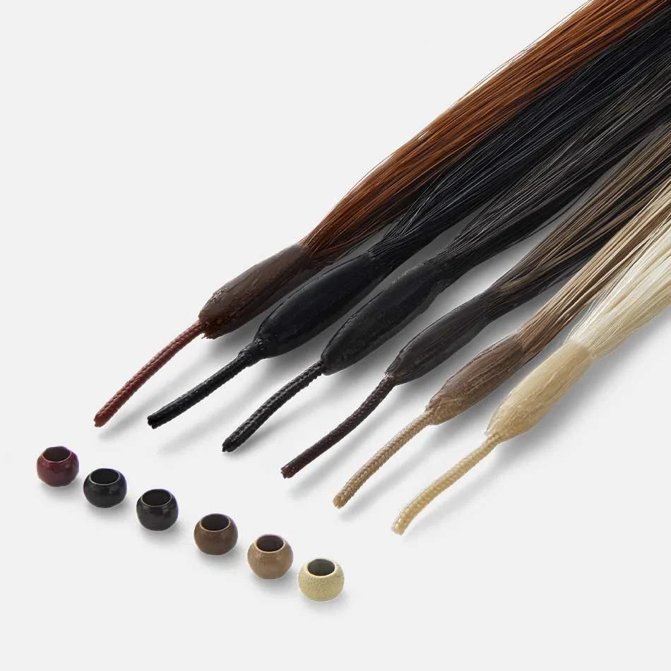 Six hair extension strands in shades from auburn to pale blonde, beside six micro rings in matching colours