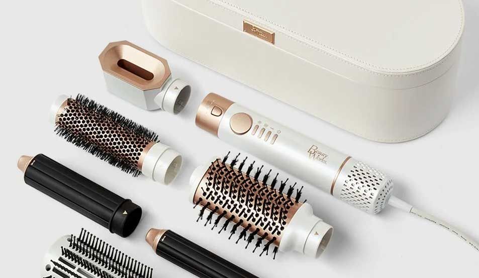 The AERIS Multi-Styler with its brush and barrel attachments laid out beside a white case