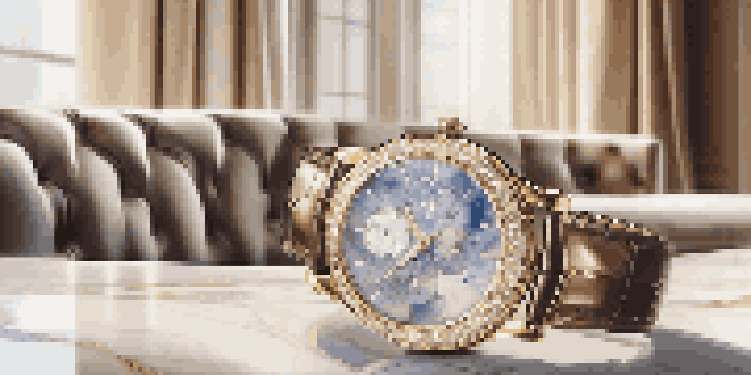A close-up of a luxury watch on a marble table, set in an elegant living room with soft lighting.