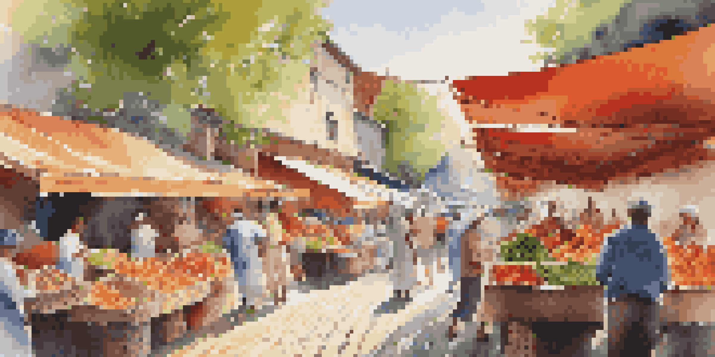 A lively outdoor market filled with colorful produce and people engaging with local vendors.