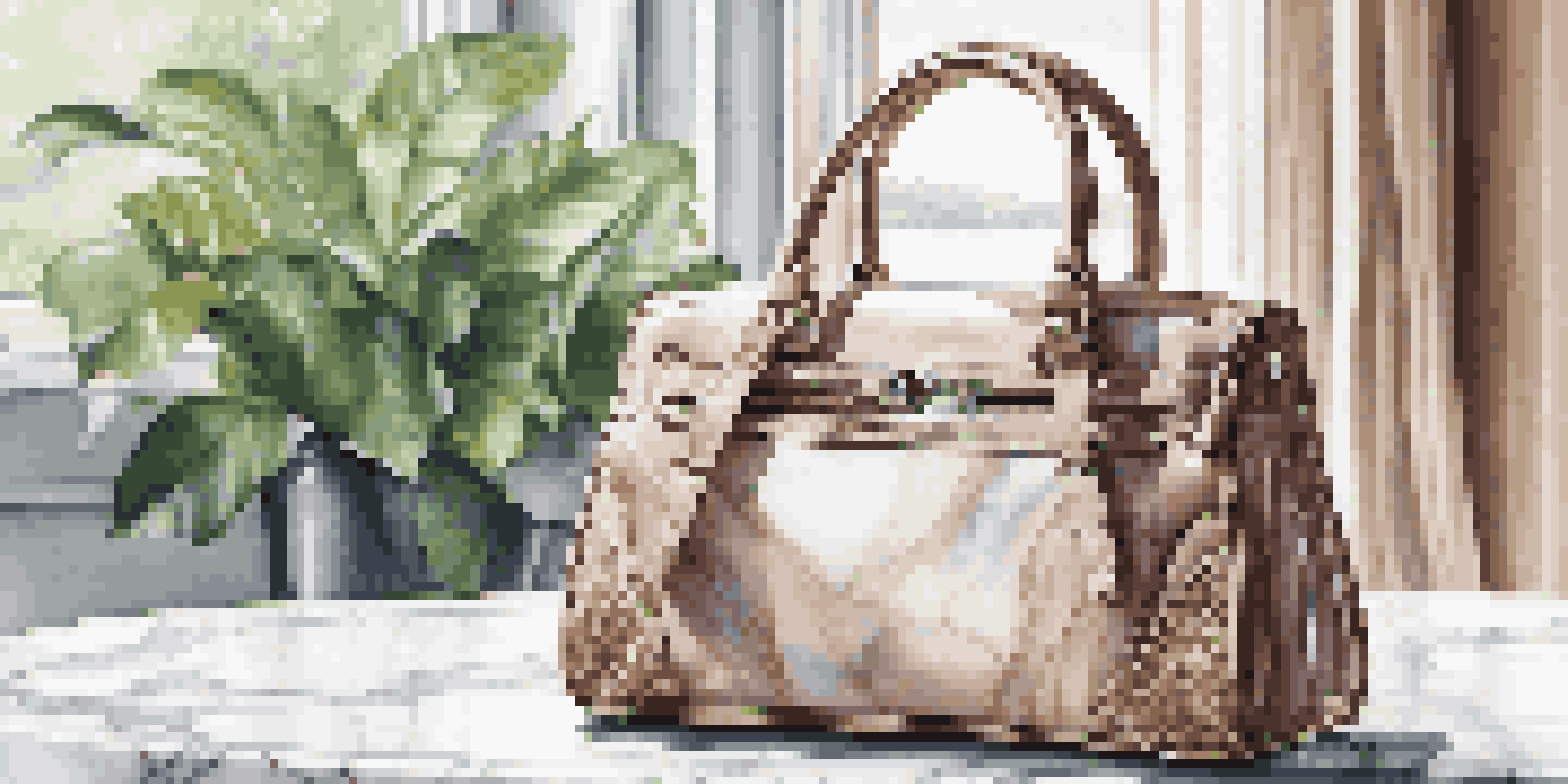 A luxurious handbag on a marble table, illuminated by natural light, with a plant and blurred cityscape in the background.
