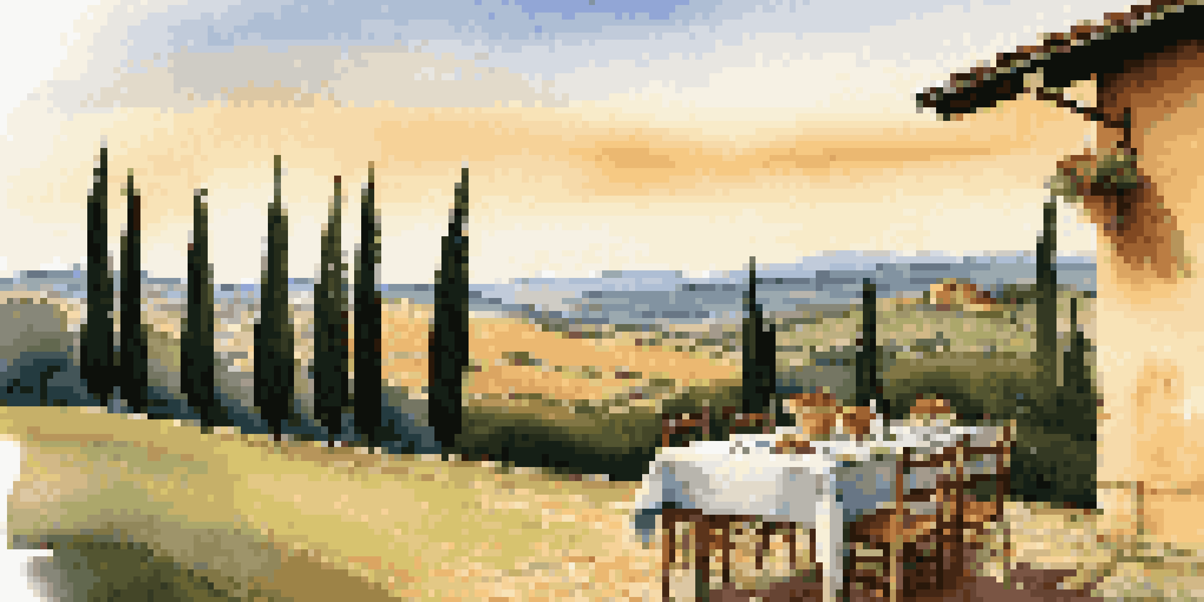 A scenic view of Tuscany with rolling hills, a farmhouse, and a table set for an Italian meal.