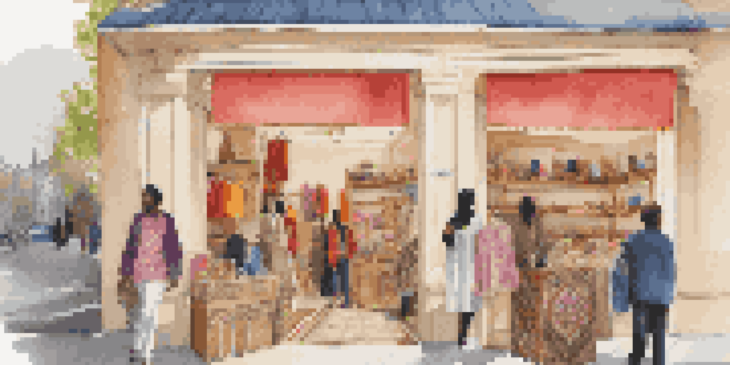 A lively pop-up shop featuring luxury goods created by refugee artisans, with colorful displays and diverse shoppers.