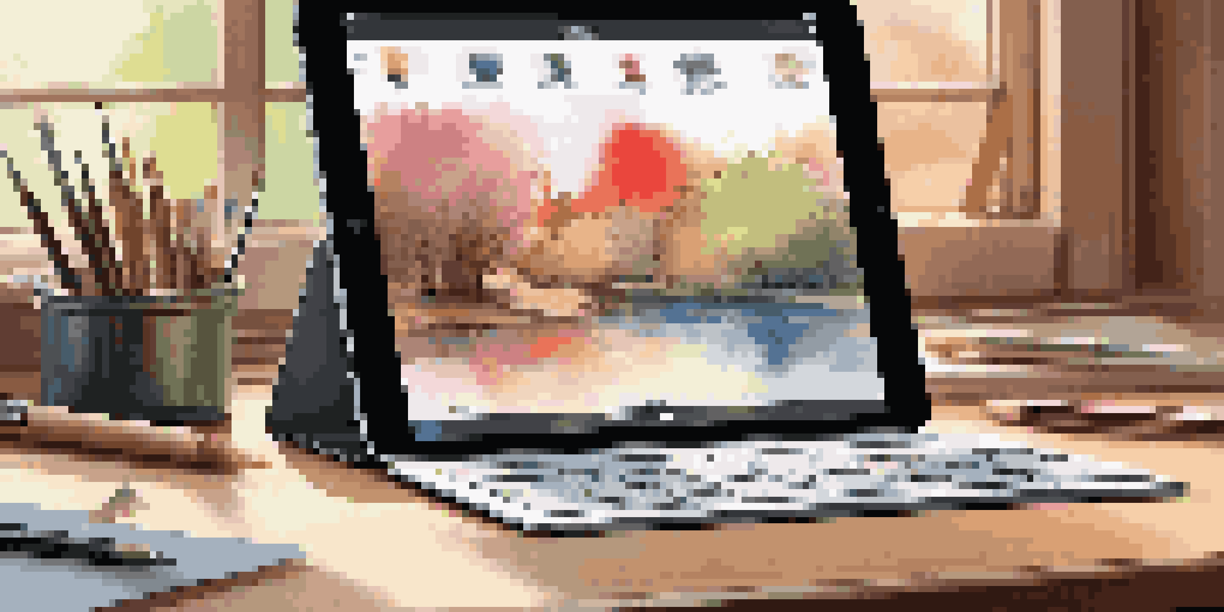 A stylish workspace showcasing an Apple iPad Pro with artistic tools and warm natural light.