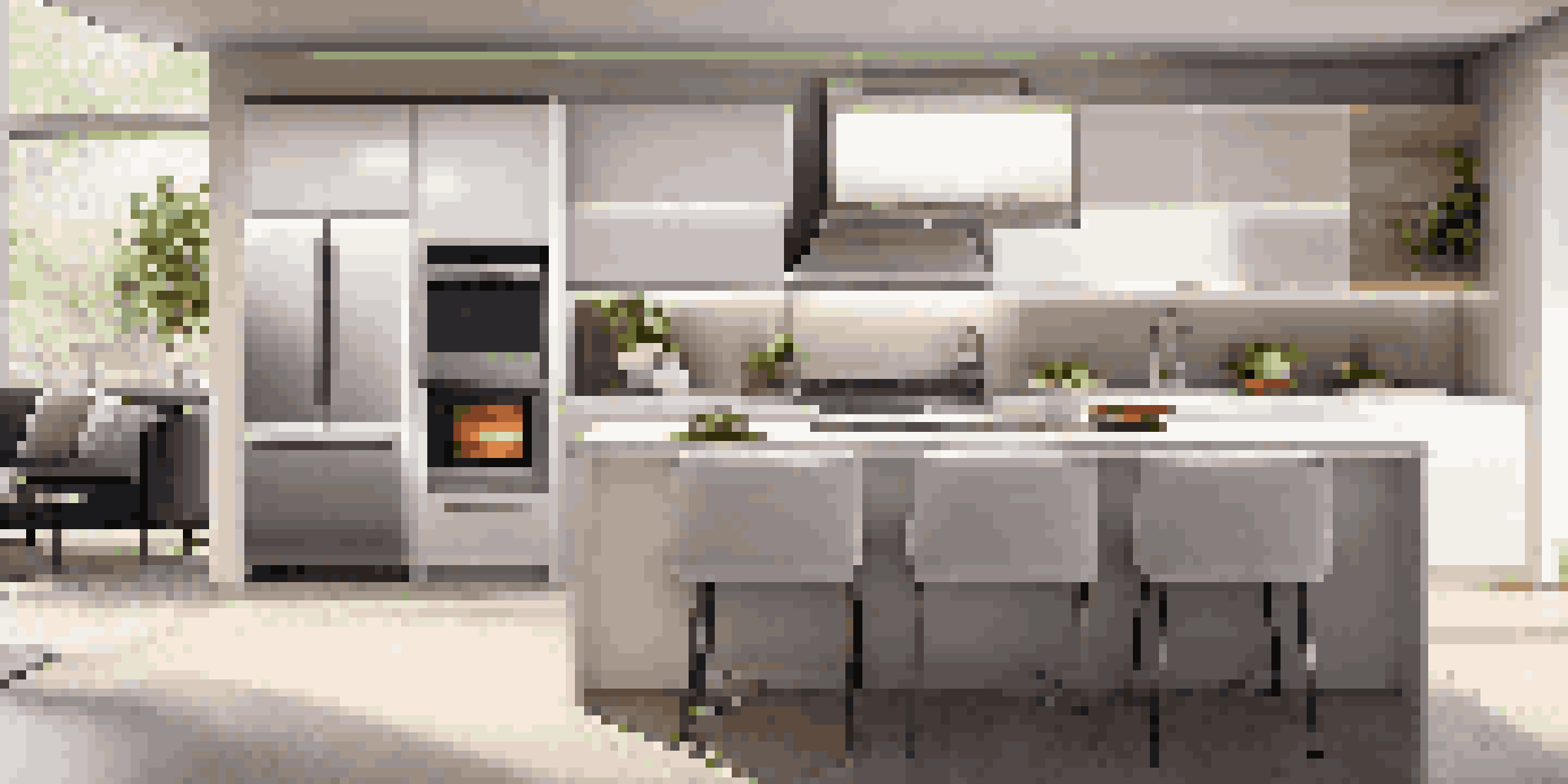 A contemporary kitchen with quartz countertops and stainless steel appliances, bright lighting, and an open layout.