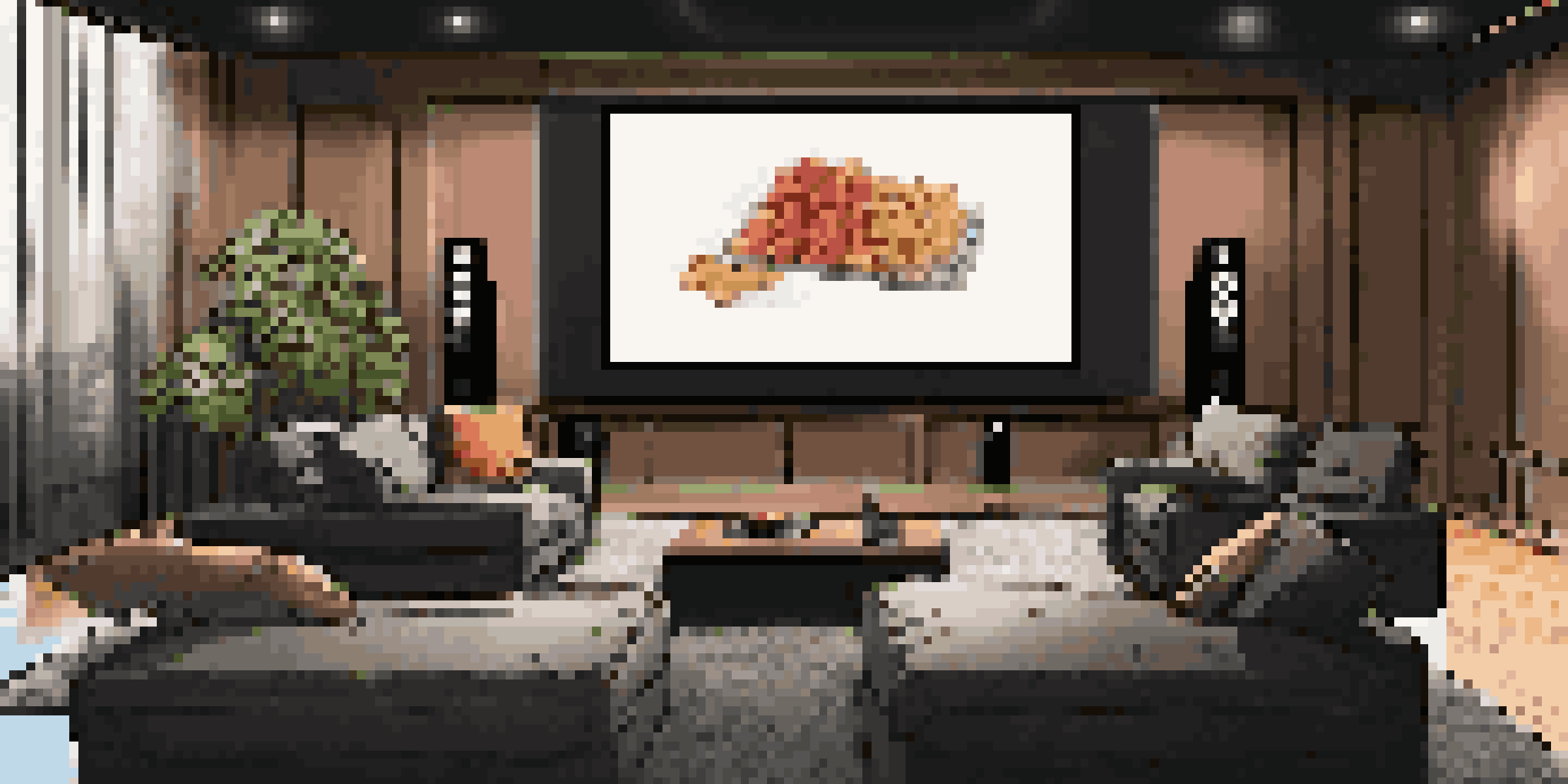 A cozy modern home theater with a large screen and surround sound speakers, dimly lit with ambient lighting and comfortable seating.