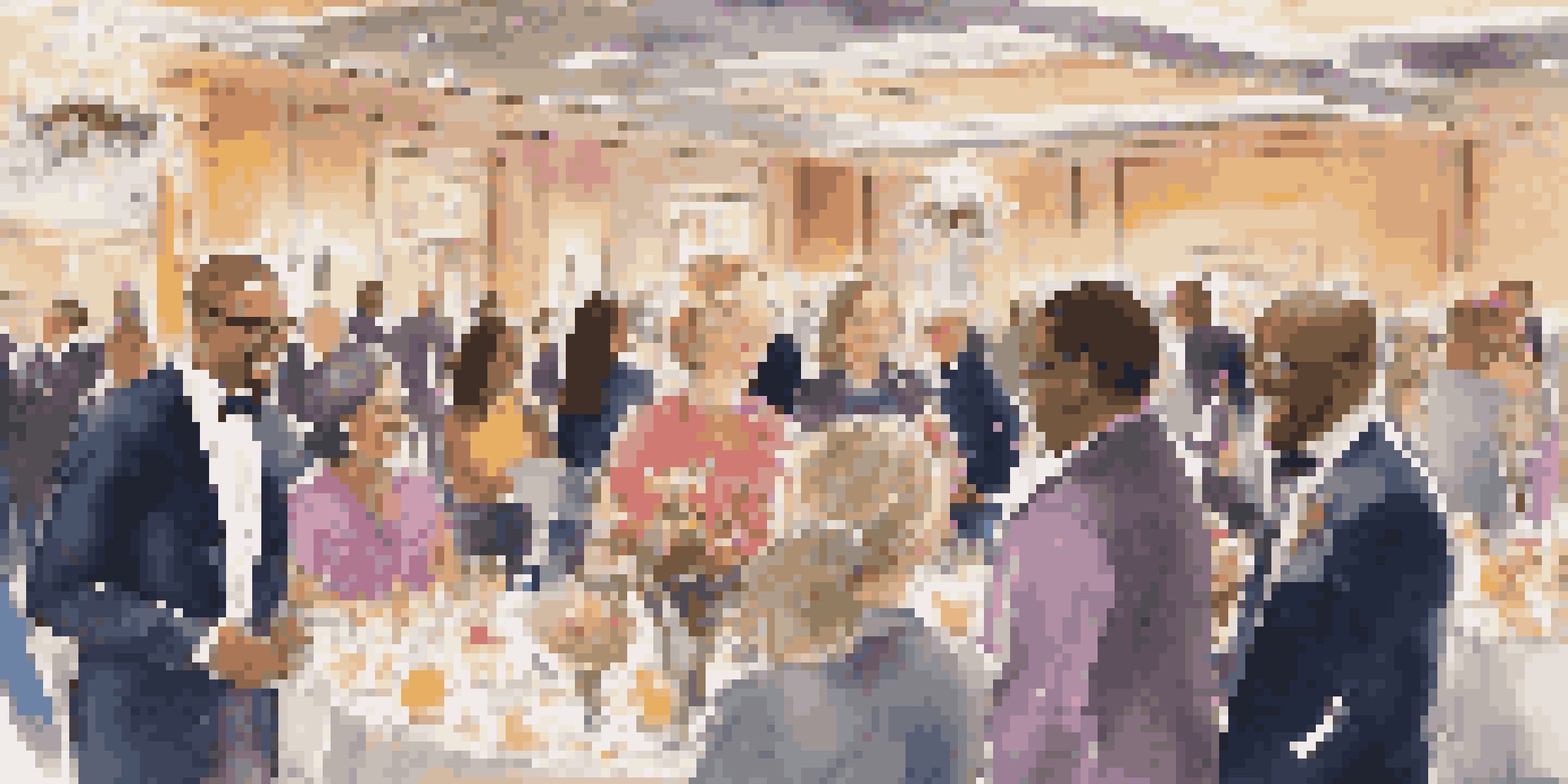 A diverse group of volunteers working together at a luxury charity event, surrounded by elegant decorations and guests in formal attire.