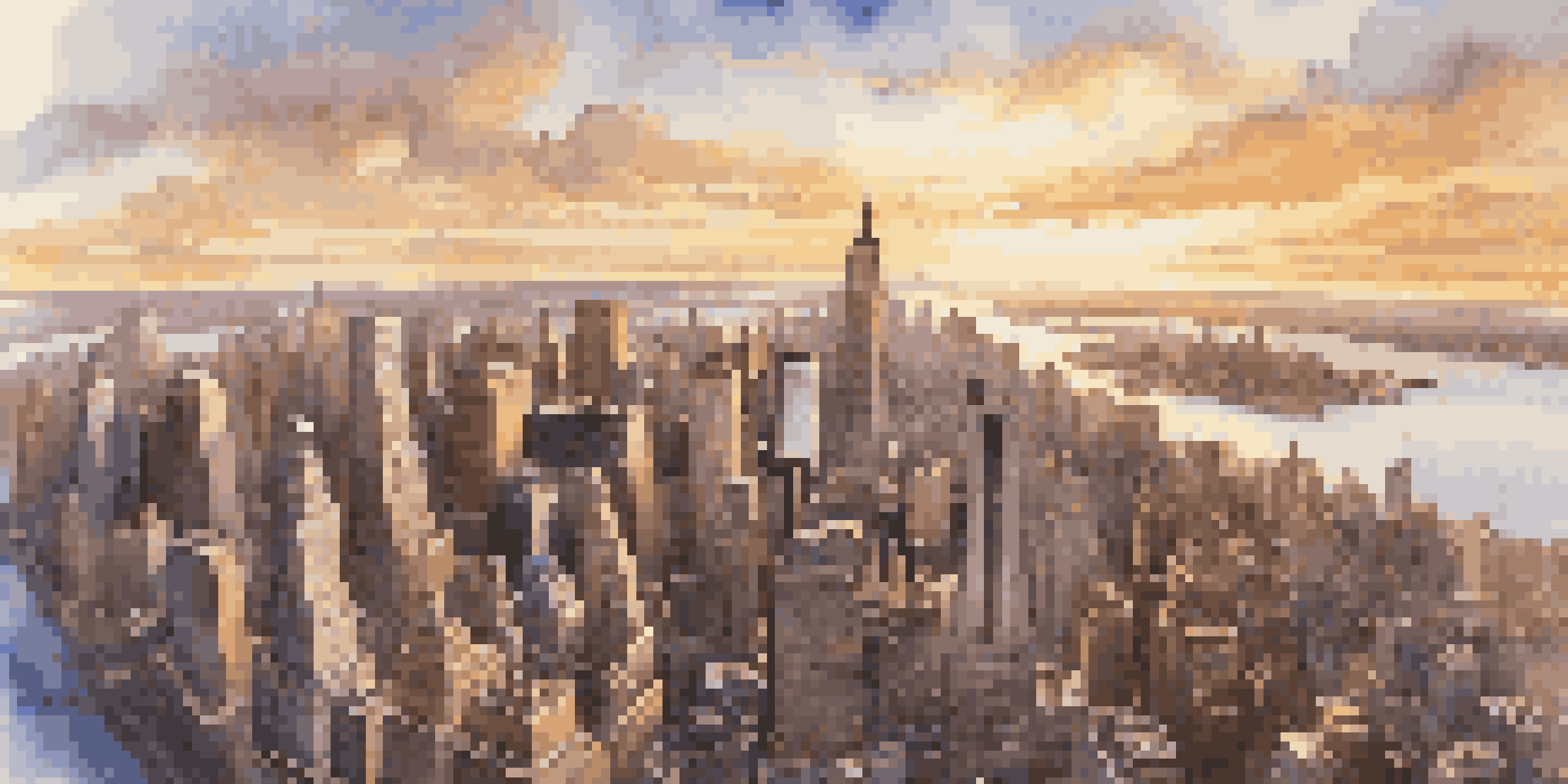 Aerial view of New York City at sunset, featuring famous landmarks illuminated by warm sunlight.