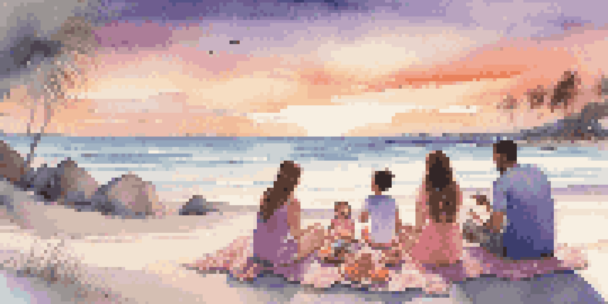 A family of four enjoying a sunset picnic on a private beach with gourmet food and a colorful blanket.