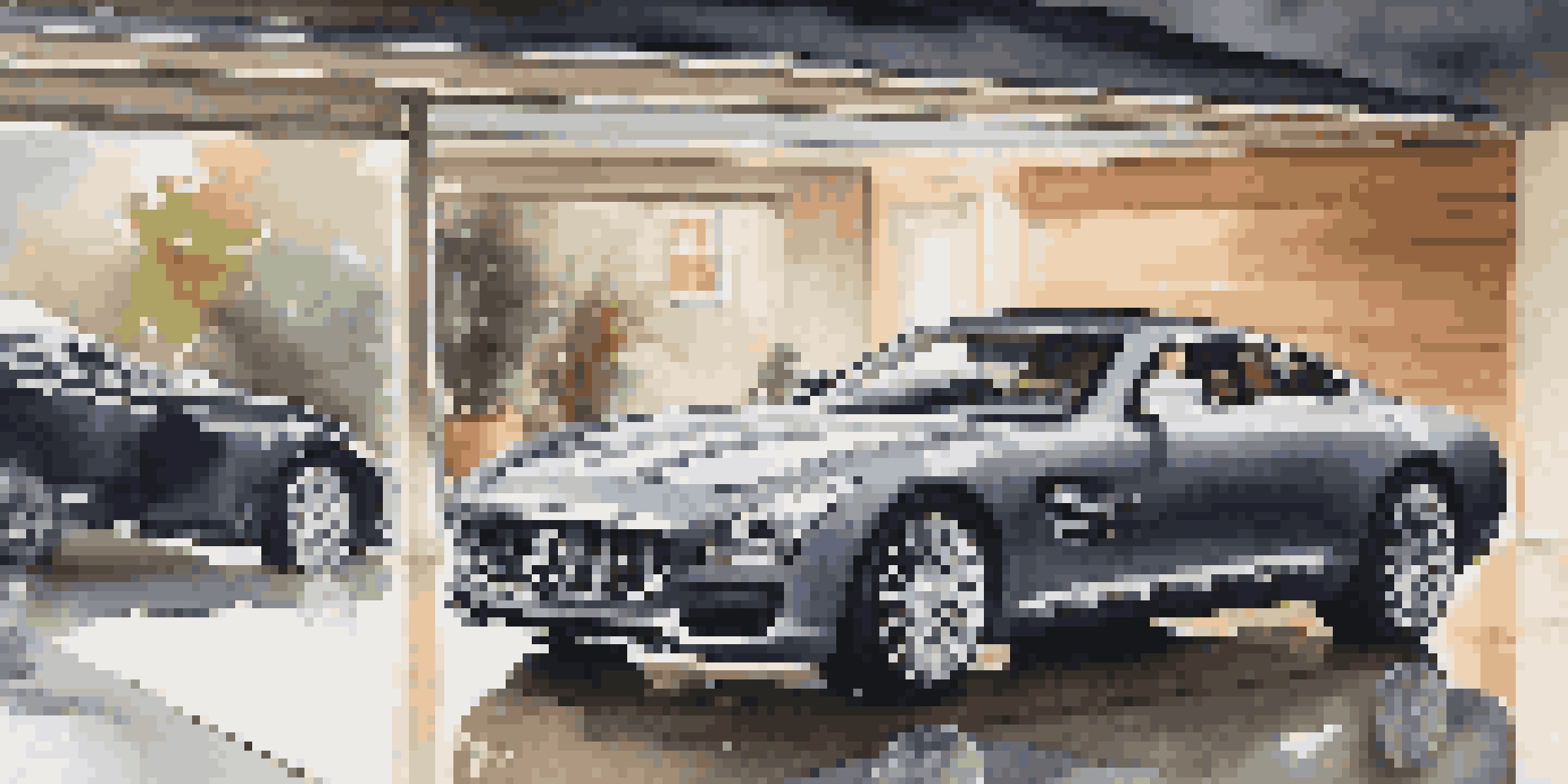 A luxurious car in a modern garage with soft lighting, showcasing its shiny exterior and elegant decor.